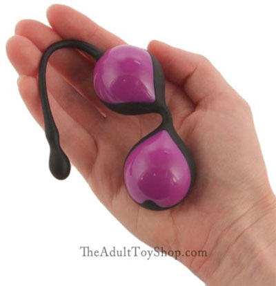 A woman holding a Kegel ball product before exercises